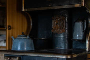 Obraz na płótnie Canvas Wooden, copper, metal old vintage pots, jars, pan, wheel in retro style. Vintage kitchenware