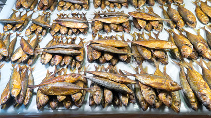 Smoked fish on the counter. Smoked fish on the counter of a small farmers market. Products and food on the market in the fish store.