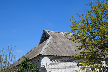 Old slate on the roof. The roof of the house is made of slate.