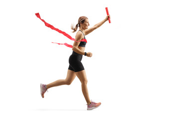 Woman finishing a relay race with a baton