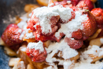 berries sprinkled with powdered sugar. sugared strawberry and apples. Homemade dessert.