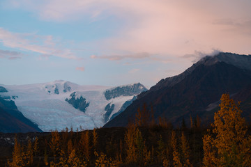 Alaskan mountains with glaciers and snow caps in autumn season during sunset
