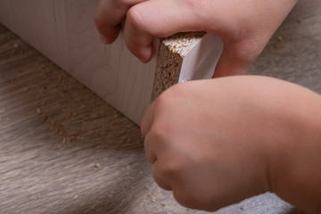 Hands of a craftsman assembling wood chipboard furniture. Tightening SCREW