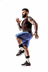 Young athlete squatting exercise with resistance band around legs. Full body length over white studio background. Isolate