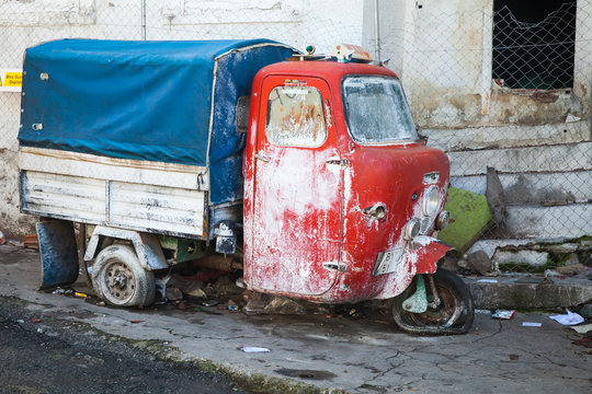 Old abandoned red and blue tricycle cargo bike
