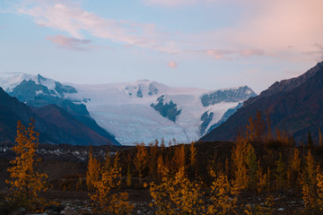 Calm morning with pink skies mountains and glaciers in Alaska during autumn season