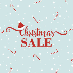 Fototapeta na wymiar Christmas sale banner with handwritten lettering isolated on blue background. Calligraphy font style banner. Xmas text decorated with Santa Claus hat. Candy background. Shopping online concept.