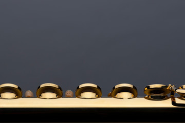 A shiny gold plated flute on a reflective surface. An instrument common in a symphony orchestra