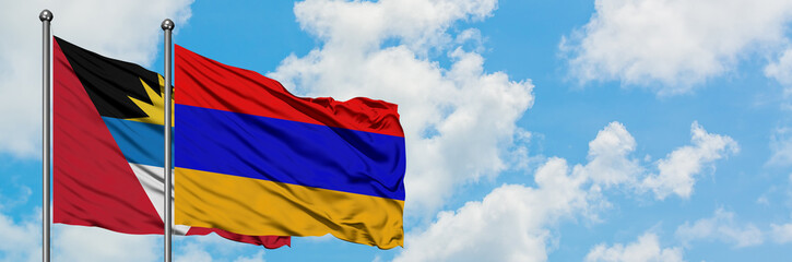 Fototapeta na wymiar Antigua and Barbuda with Armenia flag waving in the wind against white cloudy blue sky together. Diplomacy concept, international relations.