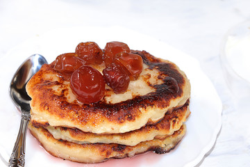 Cheesecake cottage cheese pancakes on a light table close-up, delicious healthy dessert for breakfast. Healthy eating concept,