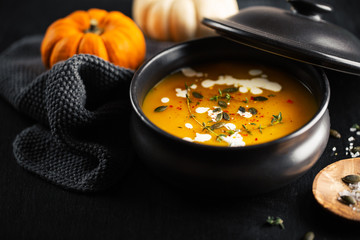 Creamy pumpkin soup served in bowl