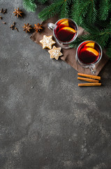 Christmas mulled red wine with spices on dark concrete background