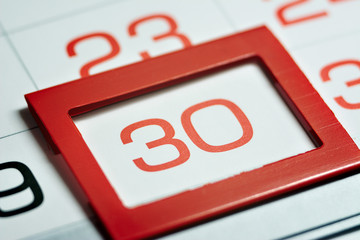 the thirtieth day of the month highlighted on the calendar with a red frame close-up macro, the...