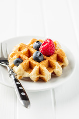 Waffles with blueberries and raspberries.