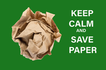 crumpled into a lump craft paper isolated on green background with inscription keep calm and save paper, forest conservation concept