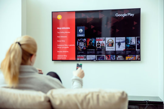 WROCLAW, POLAND - APRIL 03rd, 2018: Woman is using google play on her TV. Google Play is a digital distribution service operated and developed by Google.