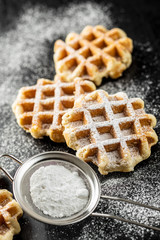 Belgian waffles sprinkled with sugar.