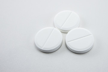 white round close-up pills macro isolated on white background