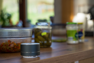Smart ai speaker with woman cooking in the background. Smart home concept