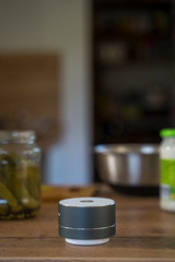 Smart ai speaker with woman cooking in the background. Smart home concept