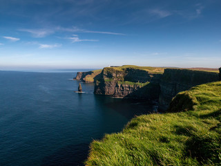 View from Cliff of Moher, county Clare, Ireland, Atlantic ocean, Sunny day, Bright blue cloudy sky. Popular Irish landmark.