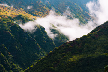 Misty morning with fog around mountains and valley