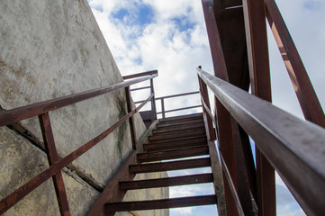 Evacuation staircase leading to a rooftop of a building.