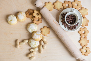 shortbread and coconut biscuits, and a cup of coffee beans on a wooden background