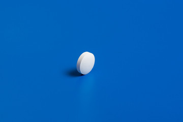 Slide of white tablets on a light table.