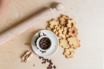 shortbread and coconut biscuits, and a cup of coffee beans on a wooden background