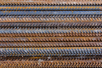 Construction rebar with traces of rust. Industrial background.