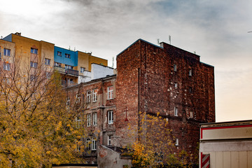 view of buildings from a backyard under a cloudy sky