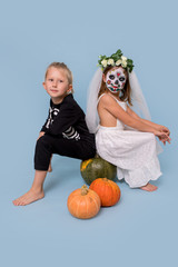 Fototapeta premium Children in a skeleton costume and a dead bride