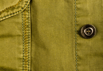 clothing items stonewashed cotton fabric texture with seams, clasps, buttons and rivets, macro