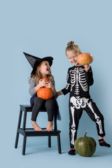 Brother and sister play and joke in halloween costumes