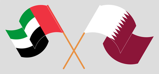 Crossed and waving flags of the United Arab Emirates and Qatar