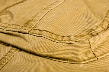 clothing items stonewashed cotton fabric texture with seams, clasps, buttons and rivets, macro