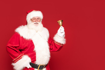 Real Santa Claus on red studio background.