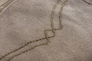 clothing items stonewashed cotton fabric texture with seams, clasps, buttons and rivets, macro