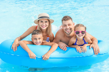 Happy family resting in aqua park