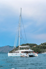 Beautiful azure blue lagoon catamaran anchored in a bay