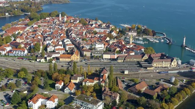 Aerial view of the city and island Lindau on lake Constance in Germany on a sunny day in autumn. Pan to the right beside the island.