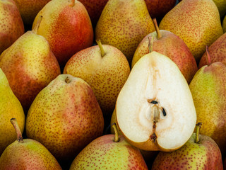 Ripe red pears lie on the counter of the village market