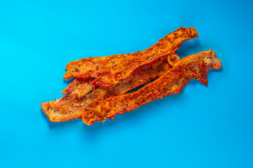 Bacon strips on a blue background