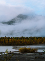 Misty morning with fog around mountains and valley