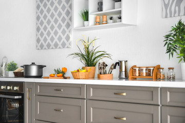 Naklejka na ściany i meble Modern interior of kitchen with green houseplants
