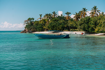 Fototapeta na wymiar Tropical beach with palm trees and boat. Ocean view