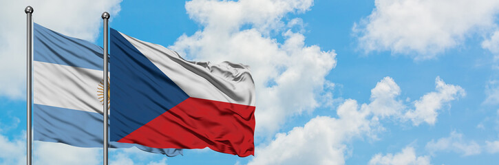 Argentina and Czech Republic flag waving in the wind against white cloudy blue sky together. Diplomacy concept, international relations.