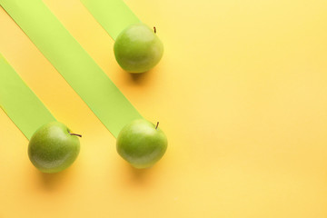 Fresh ripe apples on color background