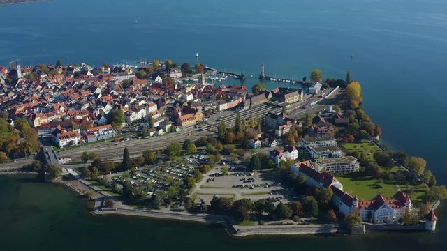 Aerial view of the city and island Lindau on lake Constance in Germany on a sunny day in autumn. Pan to the left beside the back of the island.